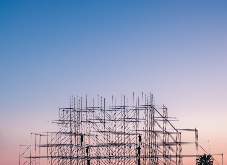 A silhouetted structure against a colorful sunset, showcasing industrial scaffolding in Sochi, Russia.
